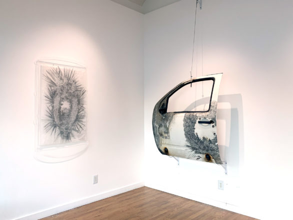 A large drawing, and a sculpture made out of a truck door